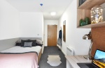 Cozy student room with bed, chair, and window at The Croft, Derby