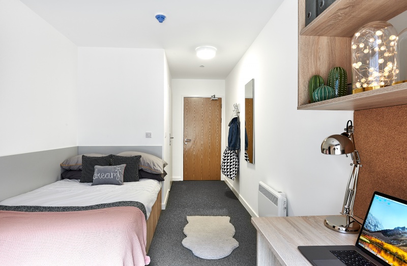 Cozy student room with bed, chair, and window at The Croft, Derby