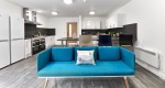 Spacious kitchen at at The Croft with modern appliances and ample counter space and a sofa