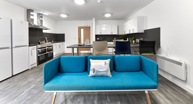 Spacious kitchen at at The Croft with modern appliances and ample counter space and a sofa