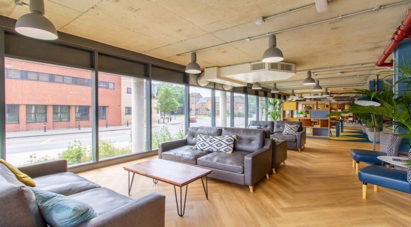 Spacious lounge area with sofas and large windows at The Croft, Derby.