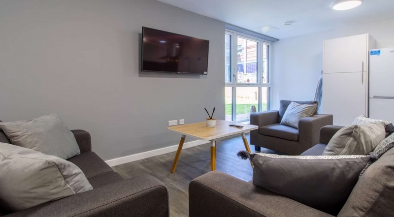 Modern living room with TV and comfortable seating at The Croft, Derby.