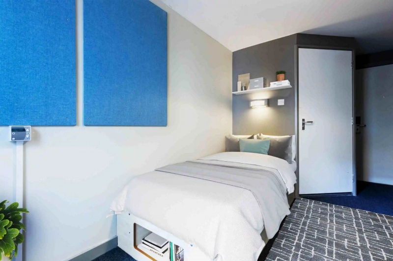 Comfortable bedroom with bed, desk, and storage at The Old Fire Station, Aberdeen