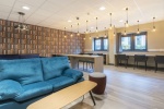Spacious communal lounge area at Lumis Student Living with sofas