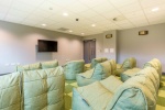 Spacious communal lounge area at Lumis Student Living with sofas and a TV