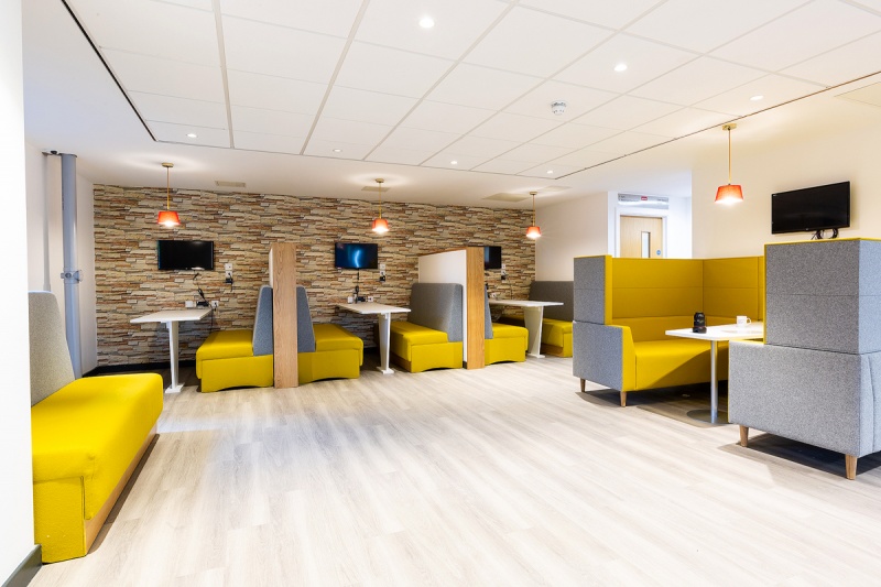 Communal area with table and sofas at Mezzino Abbey House, Coventry