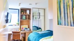 Modern student bedroom at The Neighbourhood Cardiff. Includes bed, desk, chair, storage and has a wi