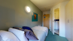 Comfortable ensuite bedroom with bed, desk, and storage at Creek Court in London