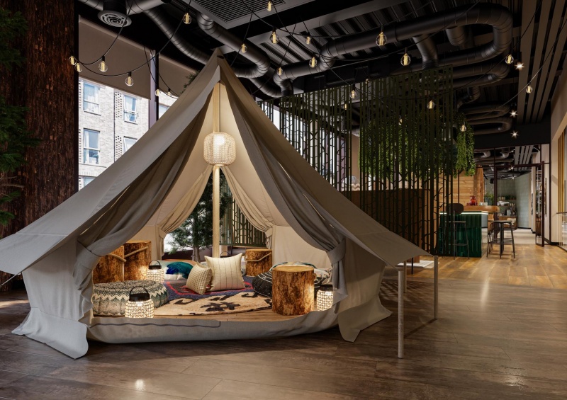 Fusion Nottingham - Tent seating area: Cozy indoor tent with cushions and wooden decor.
