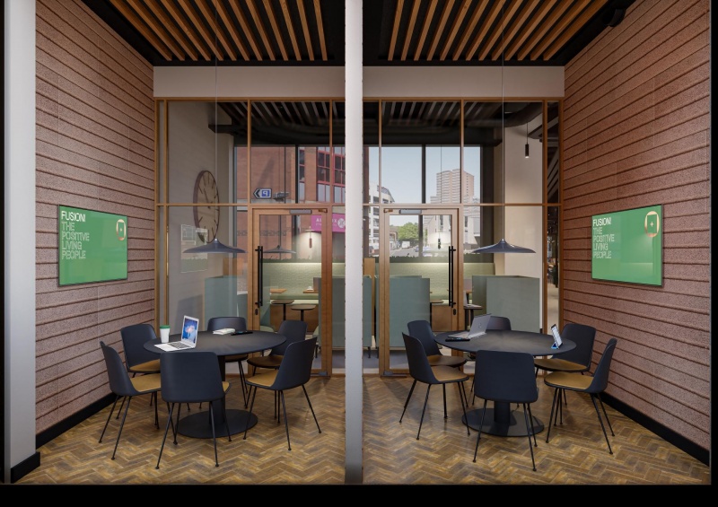 A social space with tables for group activities and collaborative work in Fusion Nottingham's commun