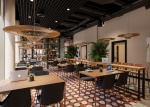 A stylish café and bar area in Fusion Nottingham, with modern seating, a large bar, and plants hangi