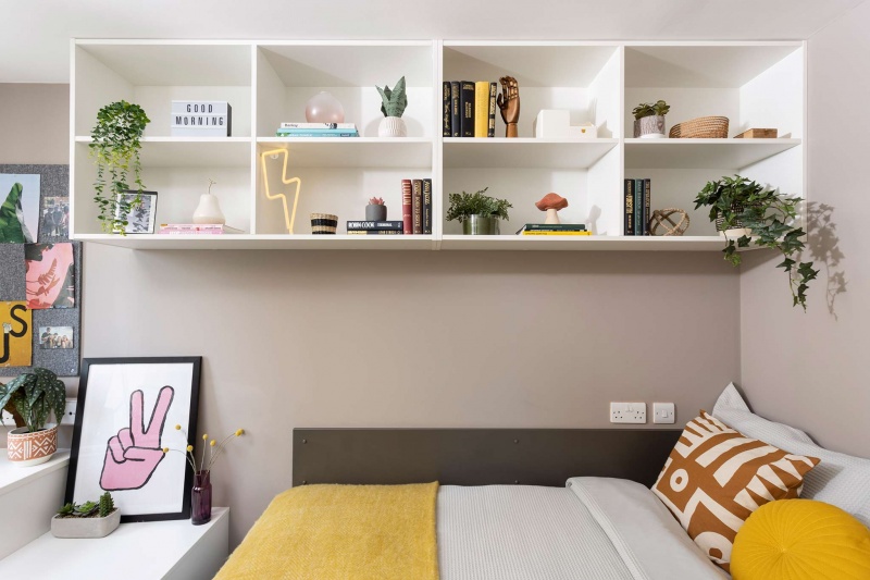 A private en-suite room at Stratford One student accommodation with a comfortable bed, study desk