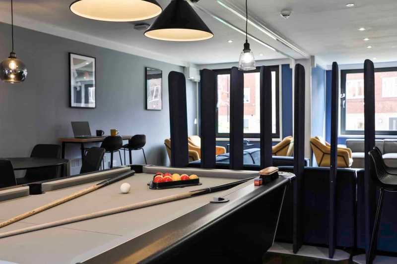Games room with a pool table in Madison Gardens student hall
