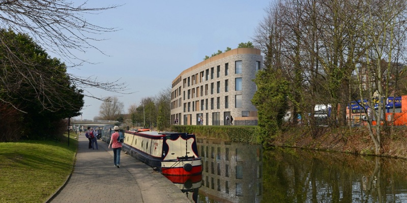 Canal-side view of Graystacks, Nottingham, with a boat and pedestrians along the pathway.