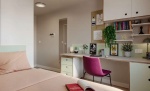 Cozy bedroom with a desk and chair at Station Court student accommodation, London