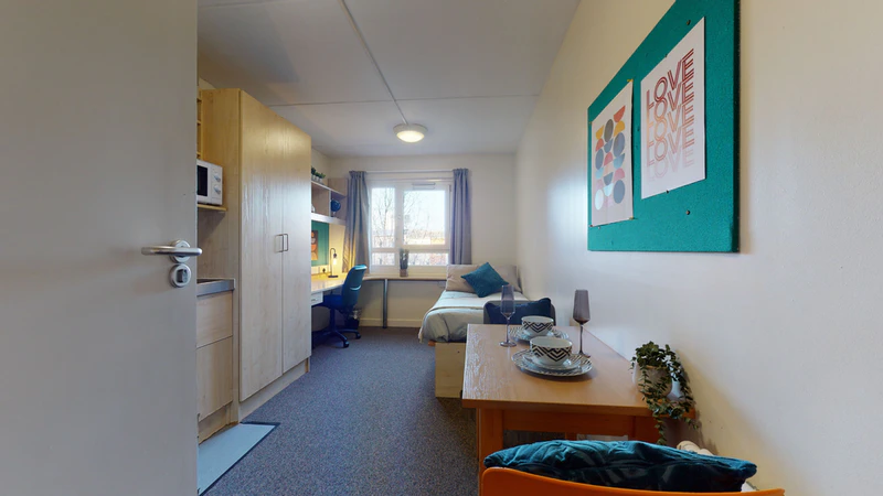 Bright bedroom with a study desk and window at Creek Court accommodation London