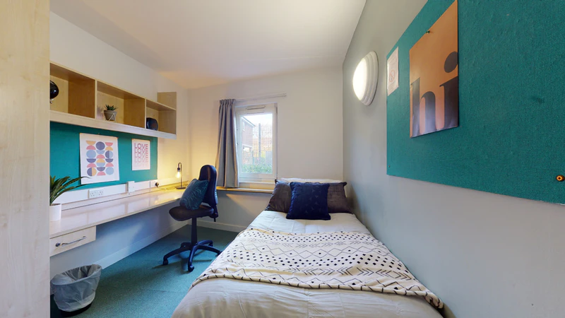Bright bedroom with a study desk and window at Creek Court London accommodation