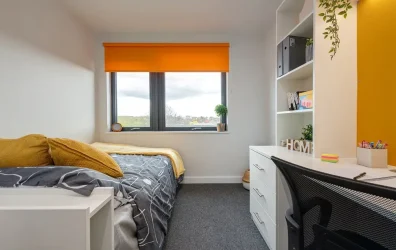 Cozy bedroom with ample storage space at Central Living student accommodation in Exeter