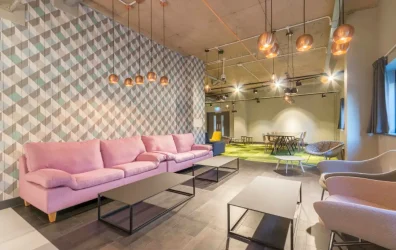 Spacious communal lounge area at Lumis Student Living with sofas