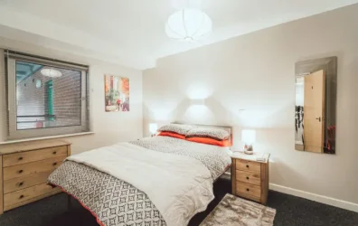 Mayfair Court Modern bedroom with a double bed, two bedside tables, and soft lighting