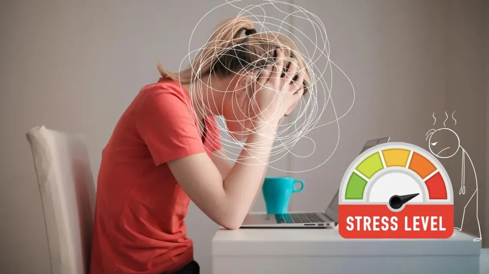 student with hands on her head feeling stress